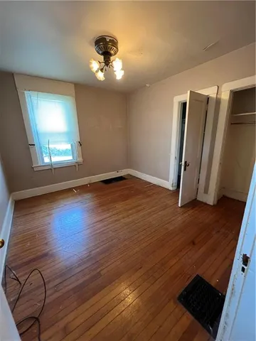 wooden floor in an empty room with a mirror