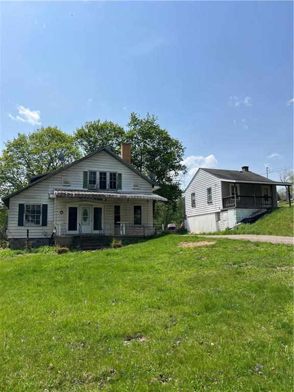 1109 Mccomb Lane Pittsburgh, PA 15239 - Photo 2 of 41 a front view of a house with a garden