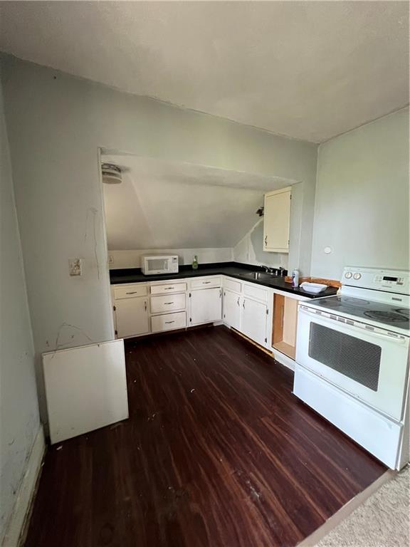 1109 Mccomb Lane Pittsburgh, PA 15239 - Photo 27 of 41 a kitchen with granite countertop a stove and white cabinets