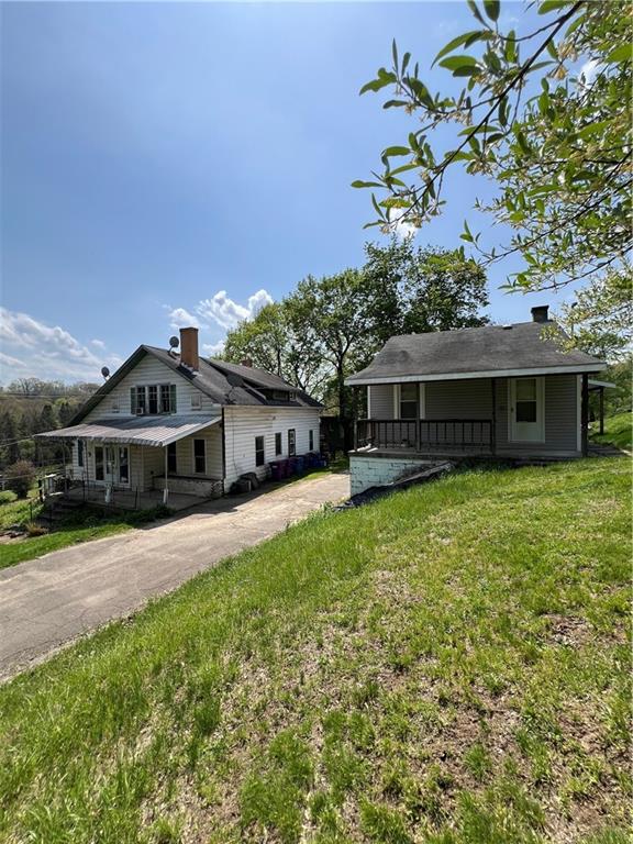 1109 Mccomb Lane Pittsburgh, PA 15239 - Photo 33 of 41 a front view of a house with a garden