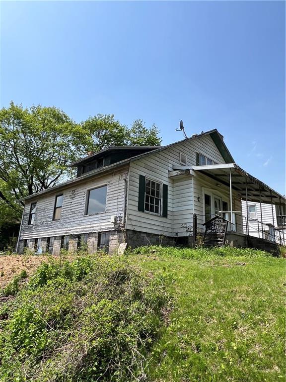 1109 Mccomb Lane Pittsburgh, PA 15239 - Photo 4 of 41 a front view of a house with a garden