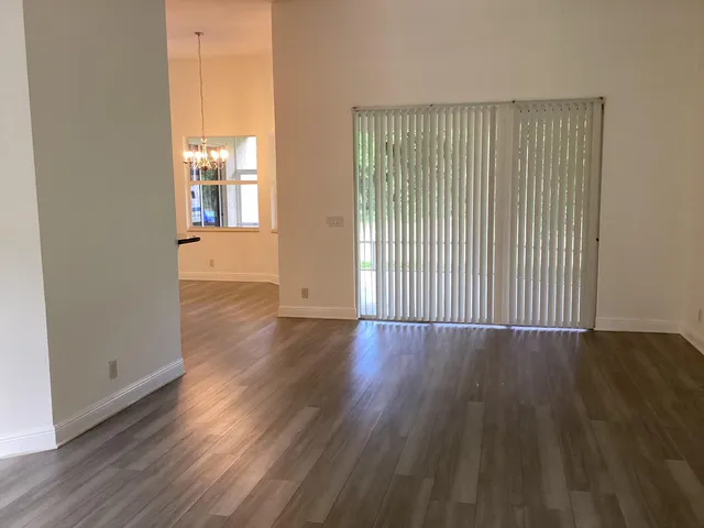 a view of a room with wooden floor and window
