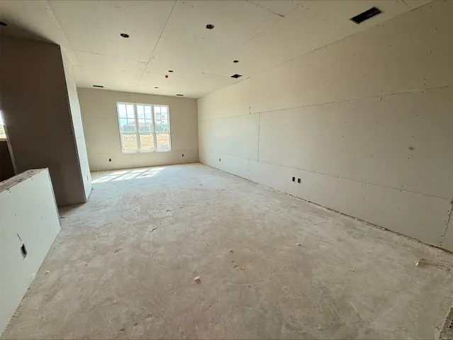 a view of a lake with a yard and large trees