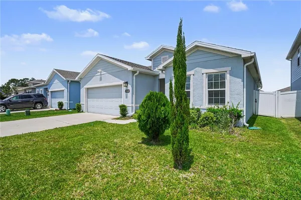 a front view of house with yard and green space