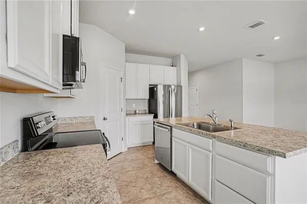 a kitchen with a sink stove and refrigerator