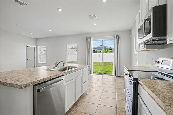 a kitchen with a sink a counter top space and appliances
