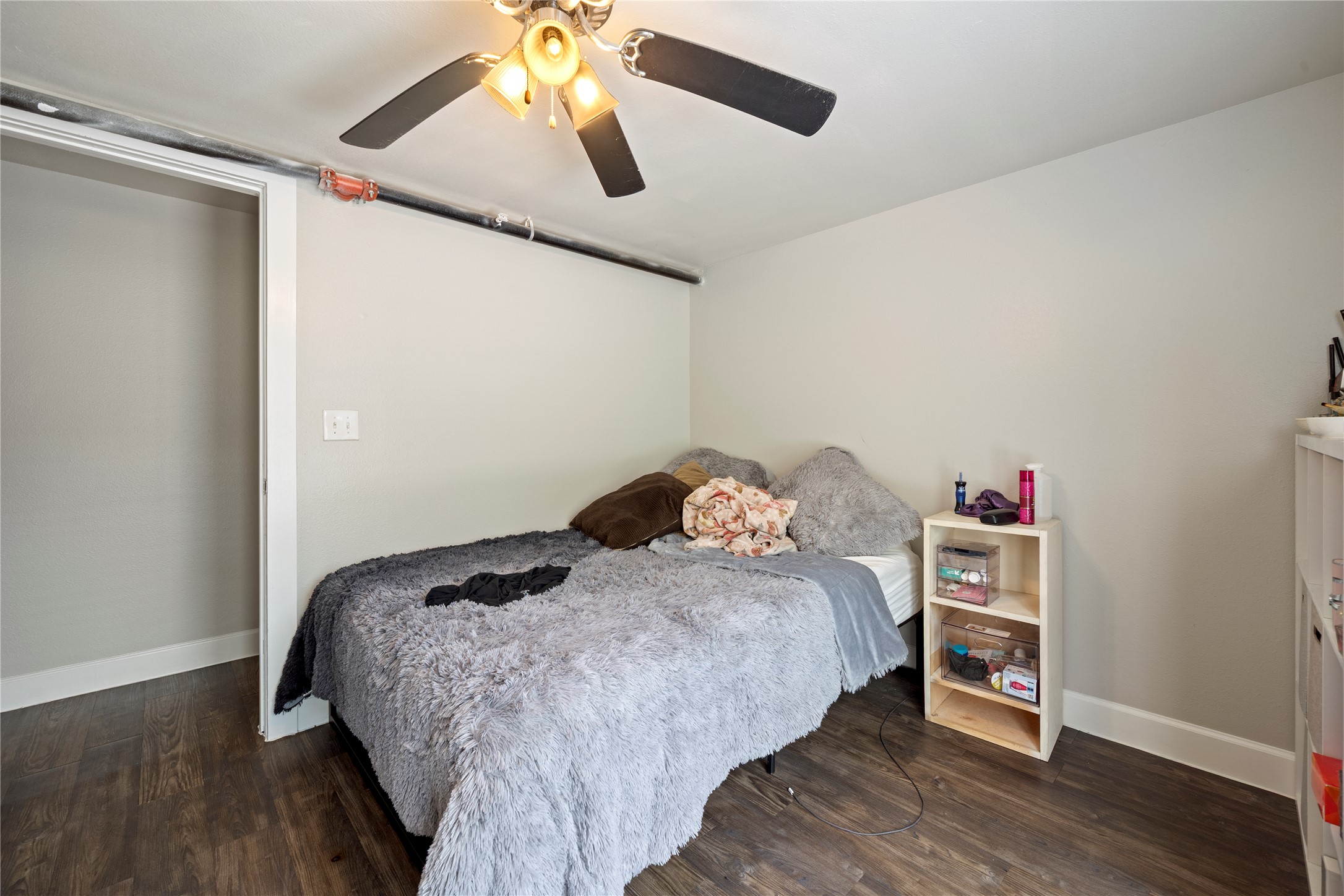 201 West 31st Street, Unit E Austin, TX 78705 - Photo 6 of 16 Wood flooring and clean walls provide a comfortable setting for this private sleeping area.