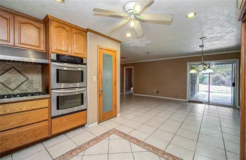 a view of a kitchen with an empty space and a stove top oven