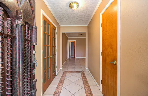 a view of a hallway with wooden floor and a glass door