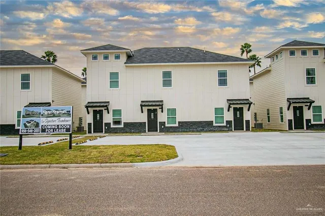 a view of a house with swimming pool and a yard