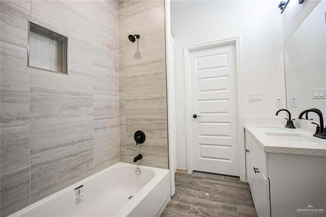 a bathroom with a bathtub and a sink