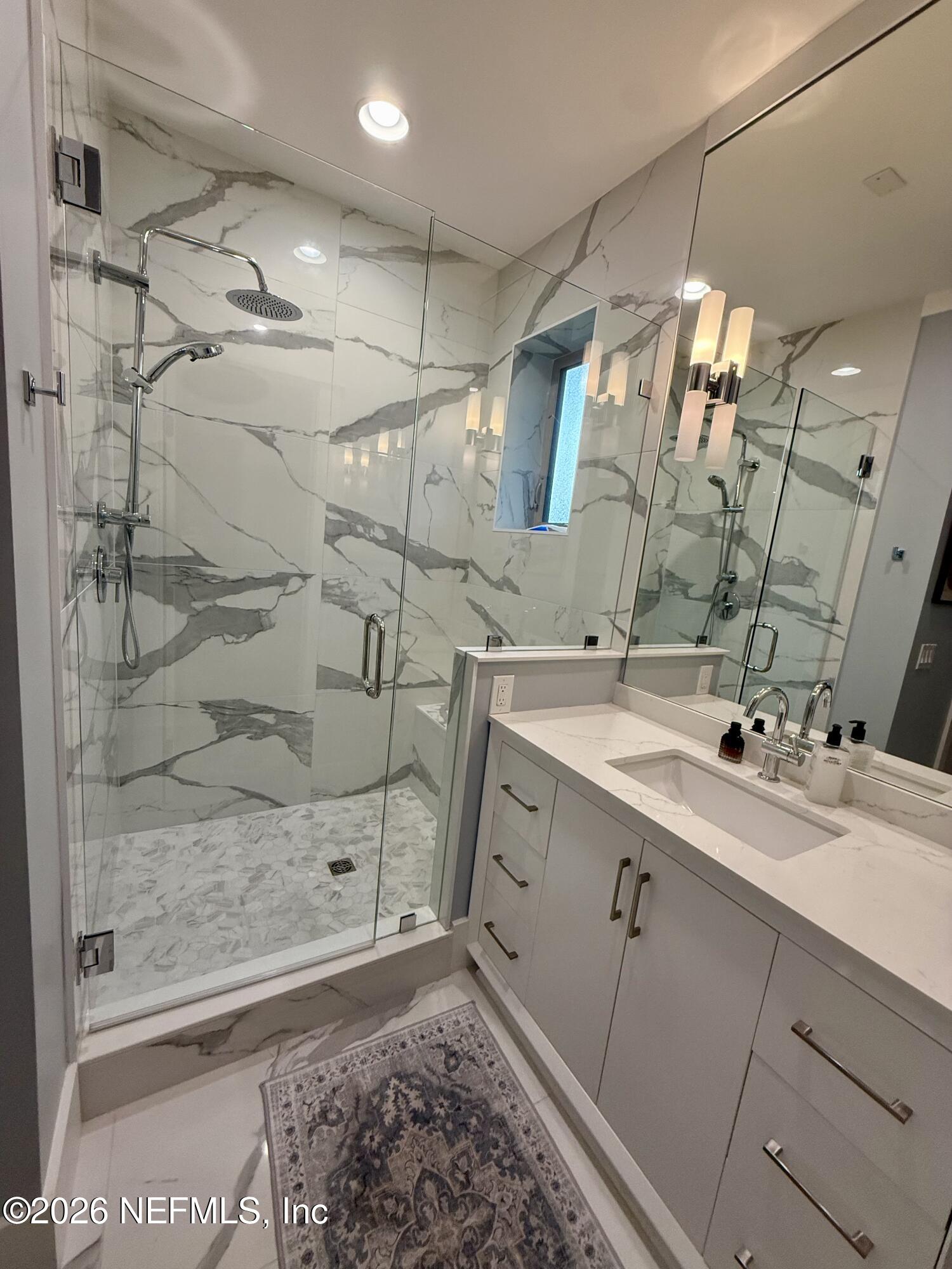 359 Ahern Street Atlantic Beach, FL 32233 - Photo 11 of 15 a bathroom with a double vanity sink mirror and shower