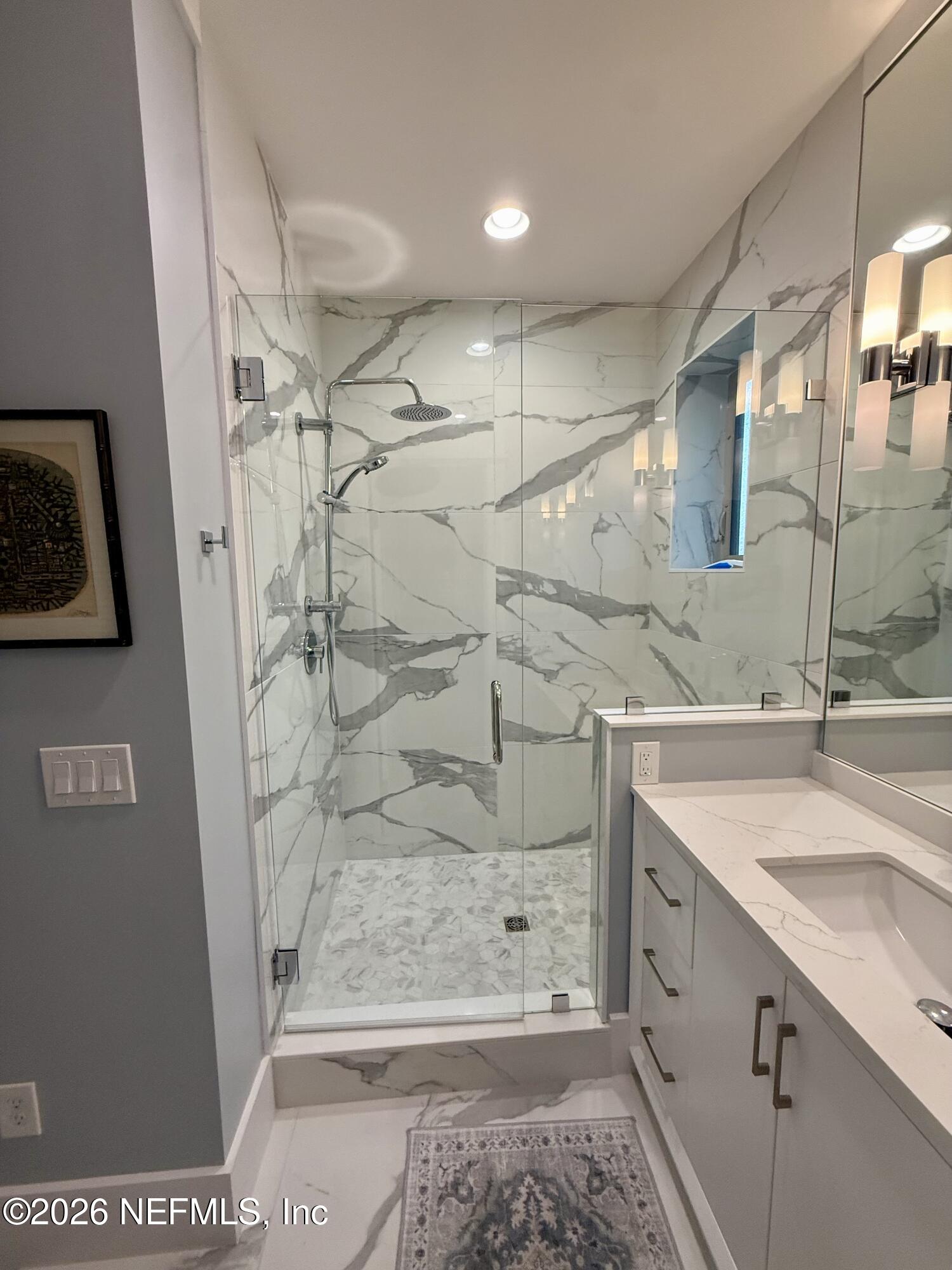 359 Ahern Street Atlantic Beach, FL 32233 - Photo 12 of 15 a bathroom with a sink and a mirror