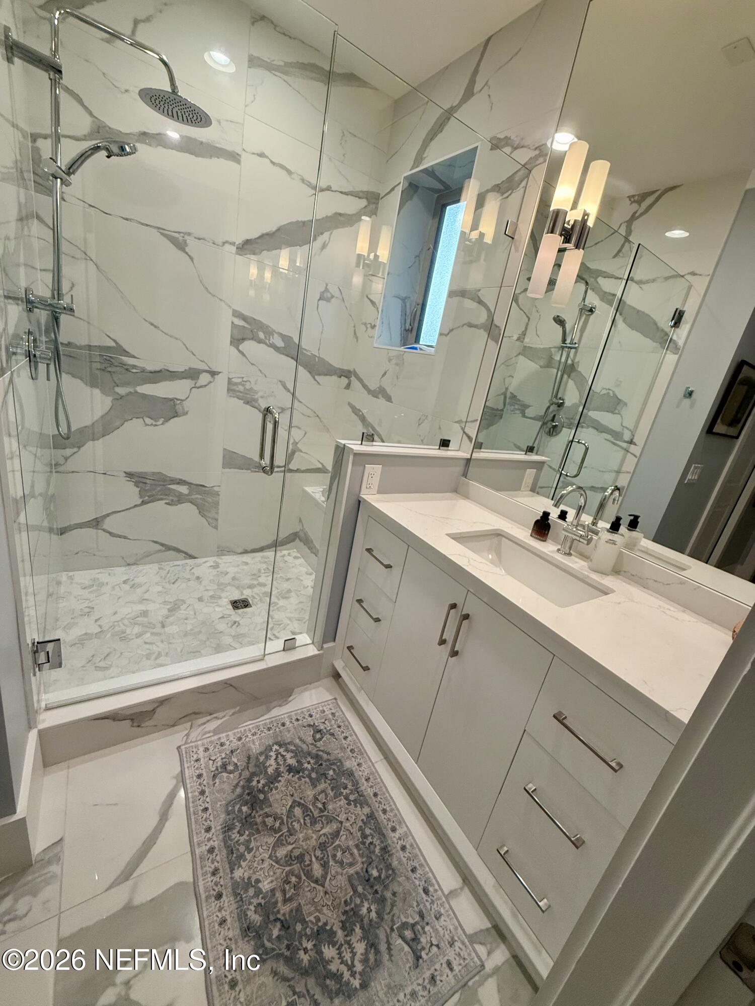 359 Ahern Street Atlantic Beach, FL 32233 - Photo 13 of 15 a bathroom with a sink mirror and shower