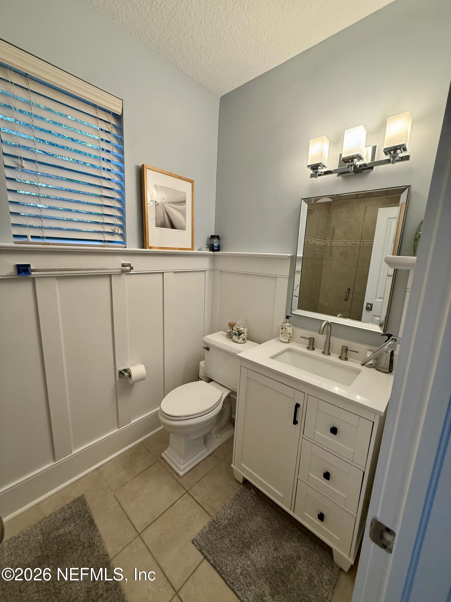 359 Ahern Street Atlantic Beach, FL 32233 - Photo 3 of 15 a bathroom with a toilet sink and mirror