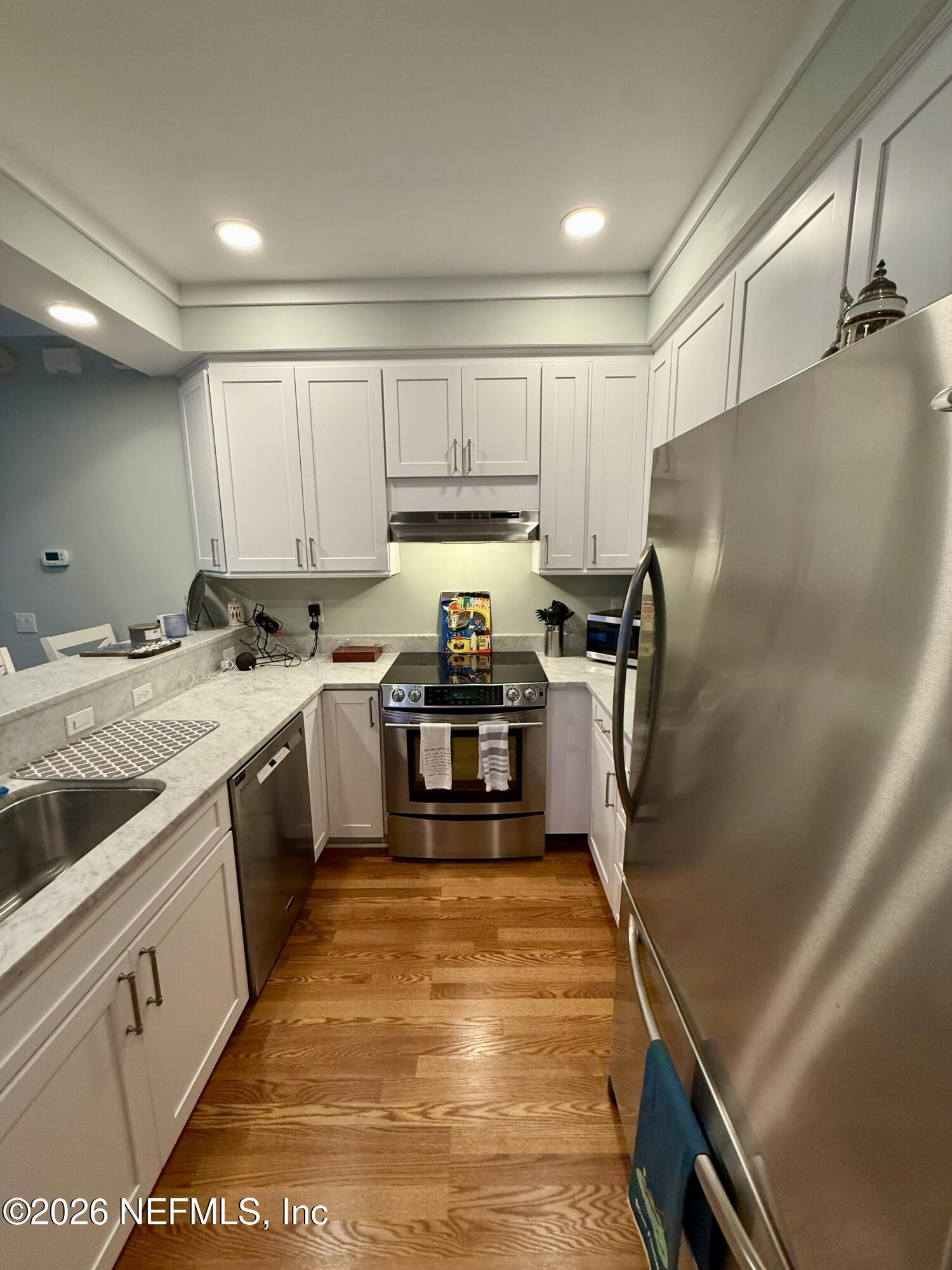 359 Ahern Street Atlantic Beach, FL 32233 - Photo 5 of 15 a kitchen with a refrigerator sink and cabinets