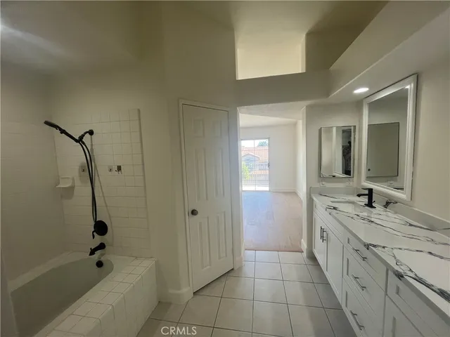 a spacious bathroom with a granite countertop sink a toilet and shower