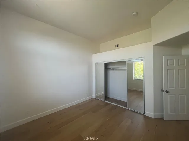a spacious bathroom with a double vanity sink a mirror and a shower