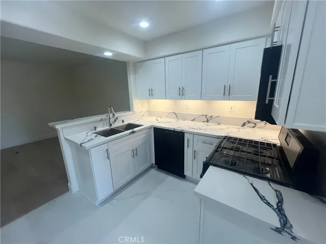 a kitchen with a sink stove and cabinets