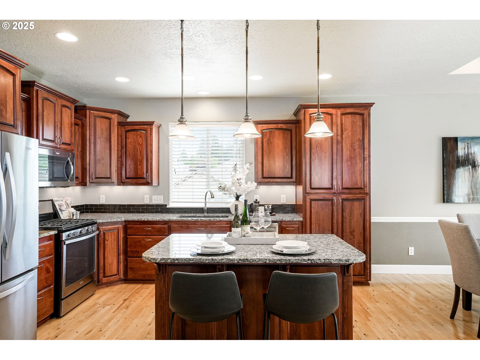 413 Northwest Harold Street Sublimity, OR 97385 - Photo 15 of 48 a kitchen with stainless steel appliances granite countertop a sink a stove and a refrigerator