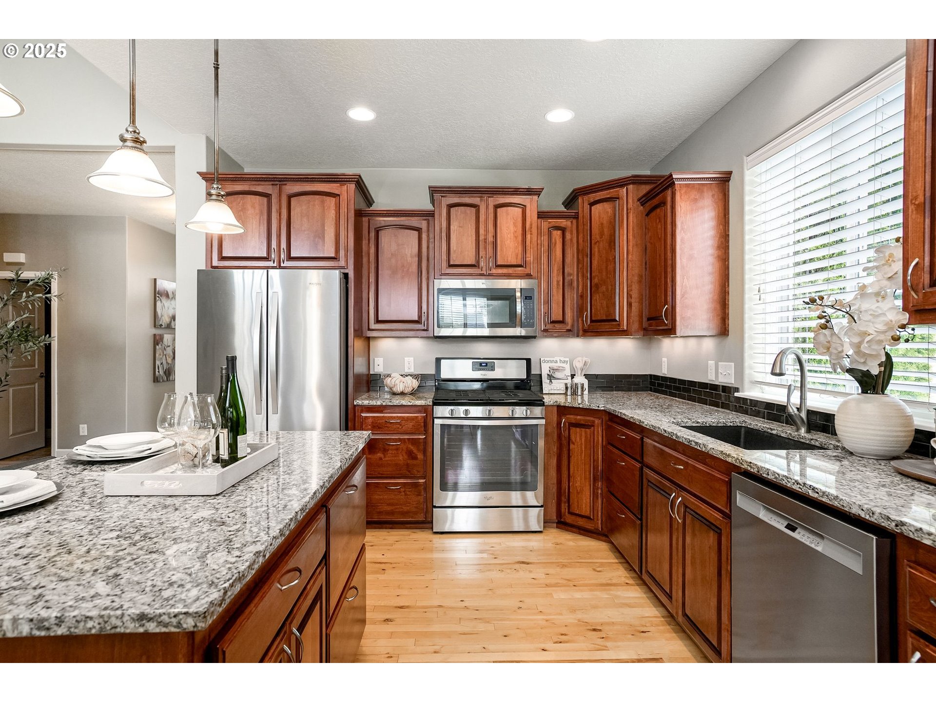 413 Northwest Harold Street Sublimity, OR 97385 - Photo 17 of 48 a kitchen with stainless steel appliances granite countertop a sink stove and refrigerator