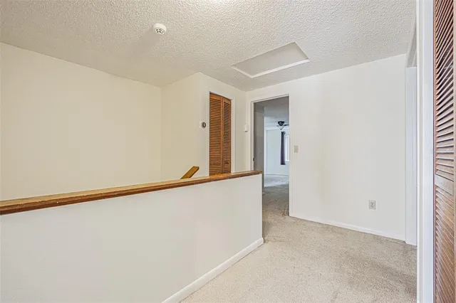 an empty room with a empty space and windows