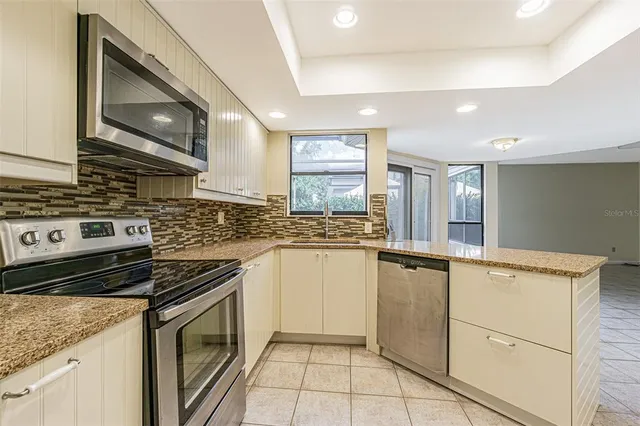 a kitchen with a stove sink and cabinets