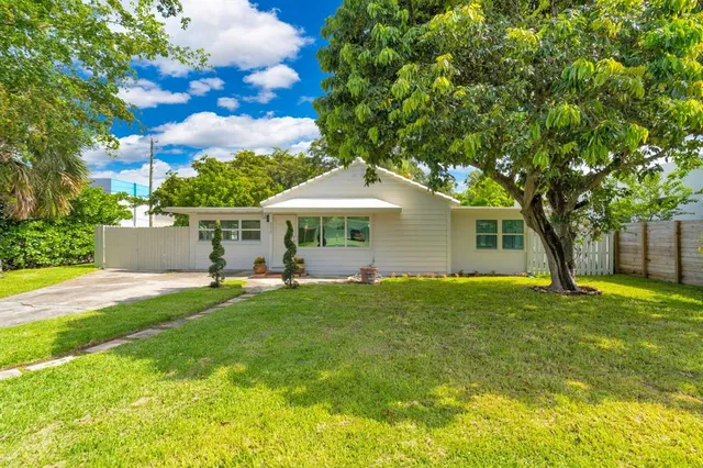 a front view of house with yard and green space