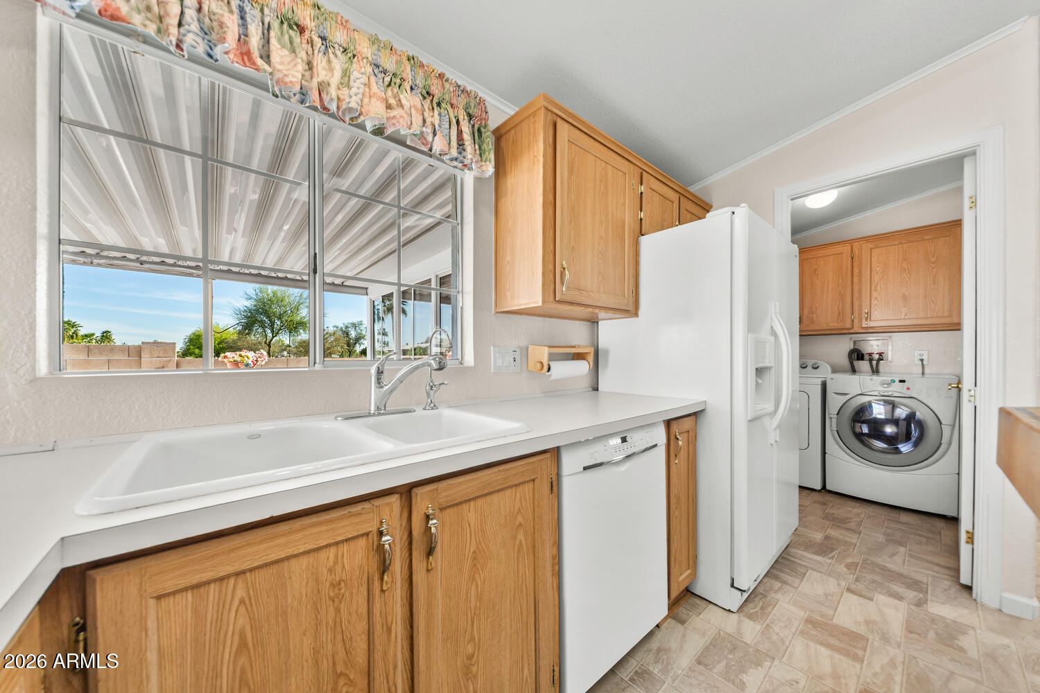 17200 West Bell Road, Unit 2251 Surprise, AZ 85374 - Photo 13 of 35 a utility room with stainless steel appliances granite countertop a sink and a window