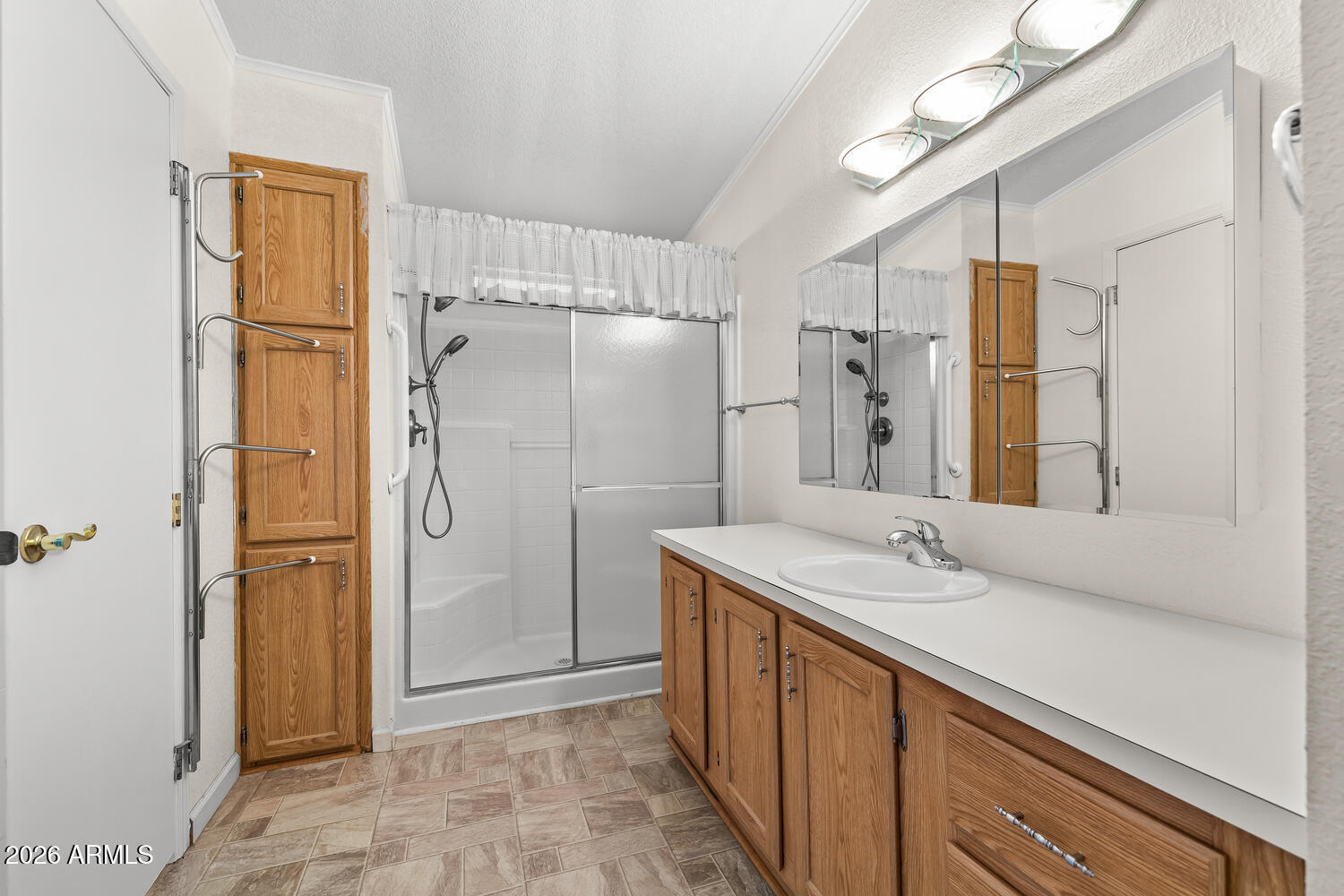 17200 West Bell Road, Unit 2251 Surprise, AZ 85374 - Photo 26 of 35 a bathroom with a granite countertop sink a shower and a mirror