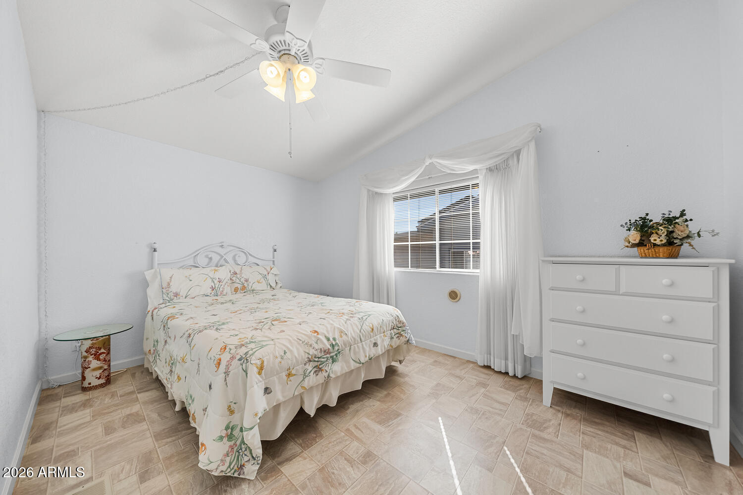 17200 West Bell Road, Unit 2251 Surprise, AZ 85374 - Photo 27 of 35 a bedroom with a bed and a chandelier