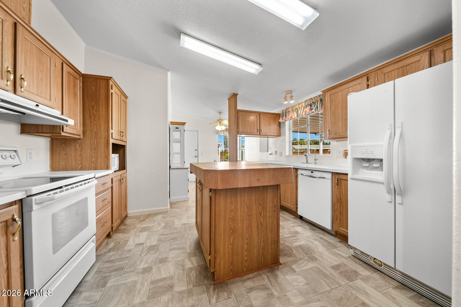 17200 West Bell Road, Unit 2251 Surprise, AZ 85374 - Photo 7 of 35 a kitchen with a sink refrigerator and cabinets