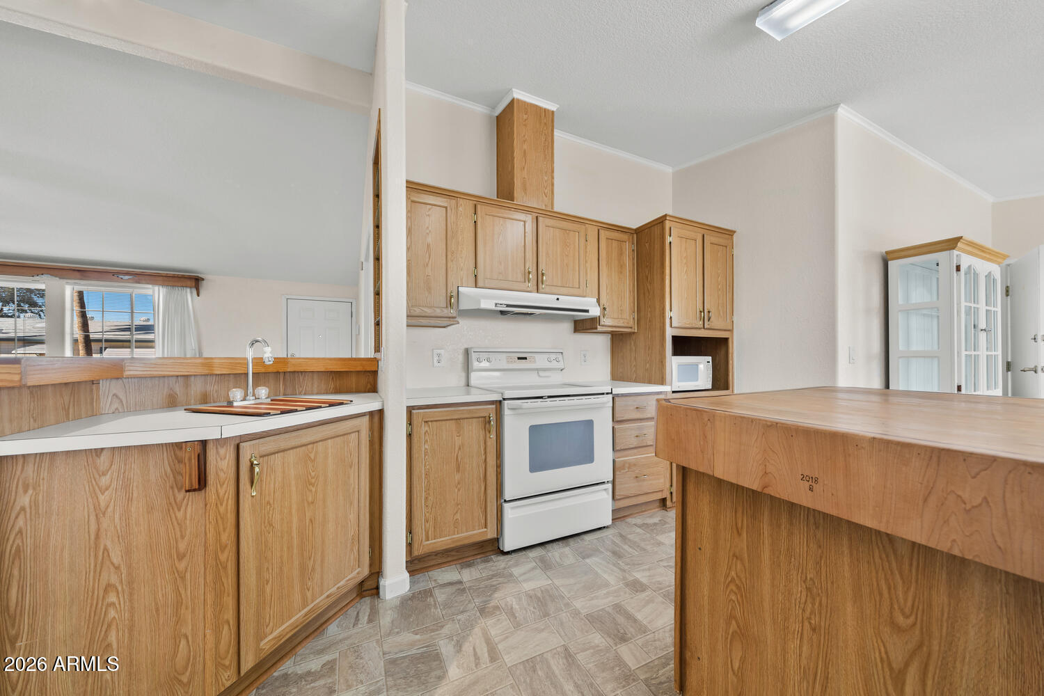 17200 West Bell Road, Unit 2251 Surprise, AZ 85374 - Photo 8 of 35 a kitchen with white cabinets sink and stove
