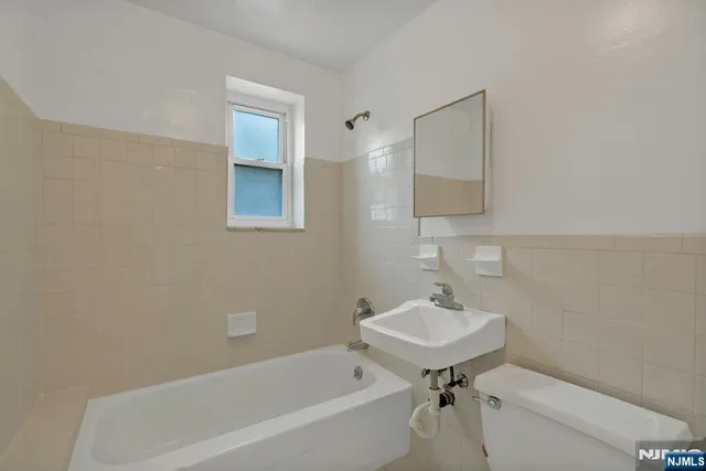 a bathroom with a sink a toilet and a bathtub