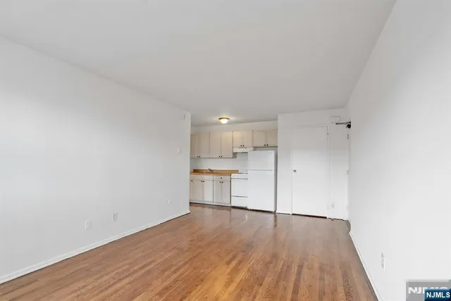 a view of a kitchen with wooden floor and a sink