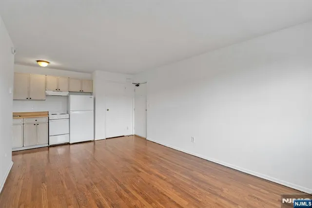 a view of a kitchen with wooden floor