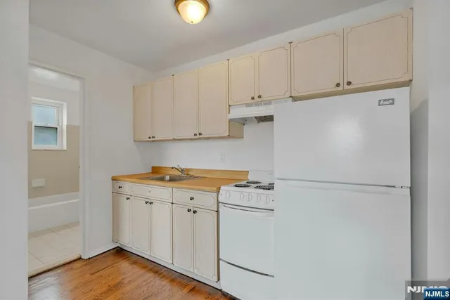 a utility room with cabinets washer and dryer