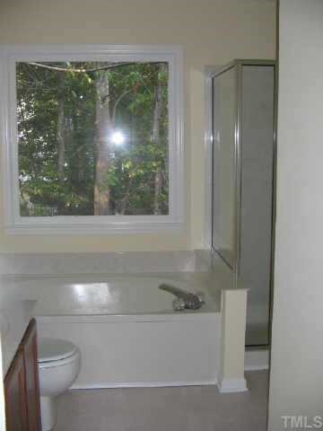 12121 Ranleigh Court Raleigh, NC 27613 - Photo 8 of 8 a bathroom with a bathtub and a toilet