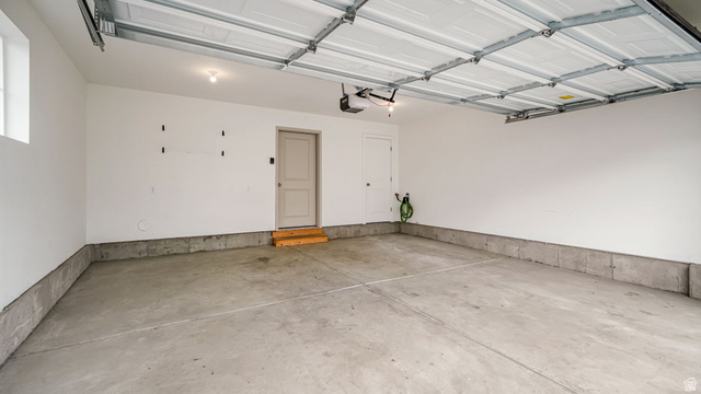1223 East 1775 North Payson, UT 84651 - Photo 29 of 45 Spacious garage featuring a concrete floor, painted walls, and an overhead door