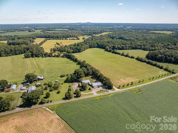an aerial view of ocean and residential houses with outdoor space
