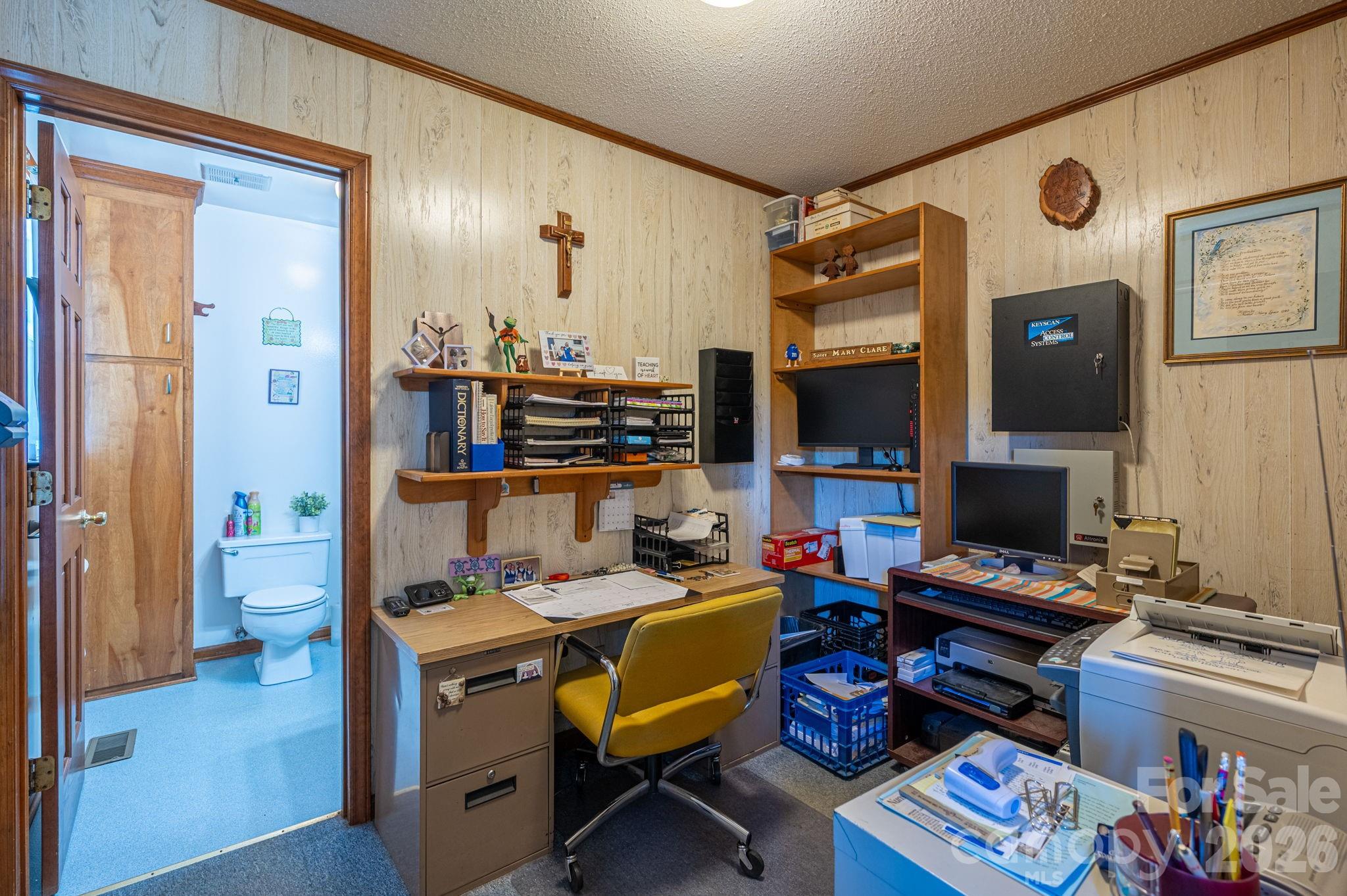 2482 June Bug Road Vale, NC 28168 - Photo 23 of 34 a view of a workspace with furniture and a flat screen tv