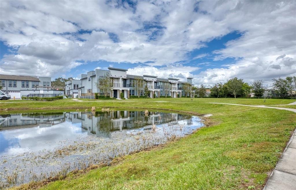 1801 Houston Street Kissimmee, FL 34743 - Photo 29 of 32 a view of a big building with a big yard and potted plants
