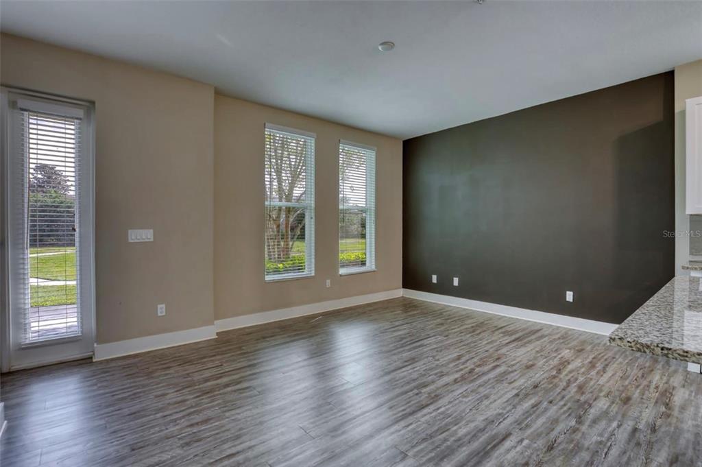 1801 Houston Street Kissimmee, FL 34743 - Photo 6 of 32 an empty room with wooden floor and windows