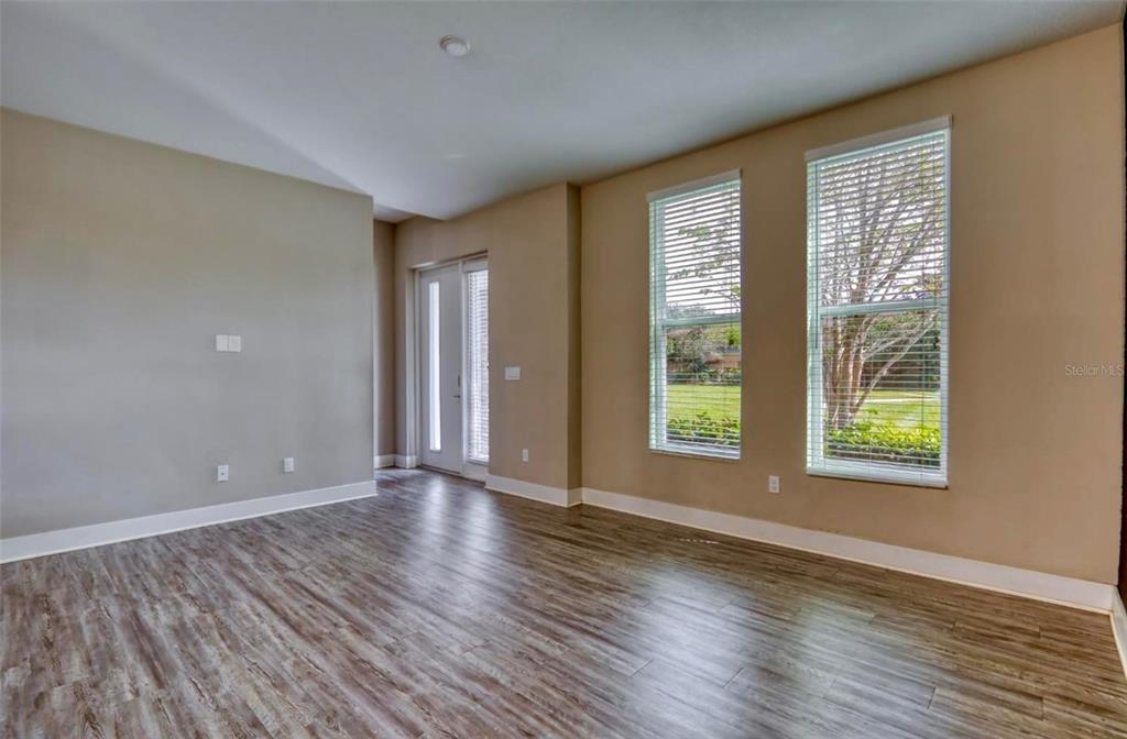 1801 Houston Street Kissimmee, FL 34743 - Photo 7 of 32 a view of an empty room with wooden floor and a window