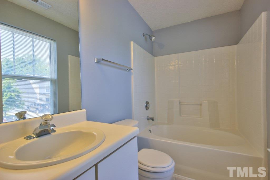 3800 Hopper Street Raleigh, NC 27616 - Photo 12 of 18 a bathroom with a sink toilet and bathtub