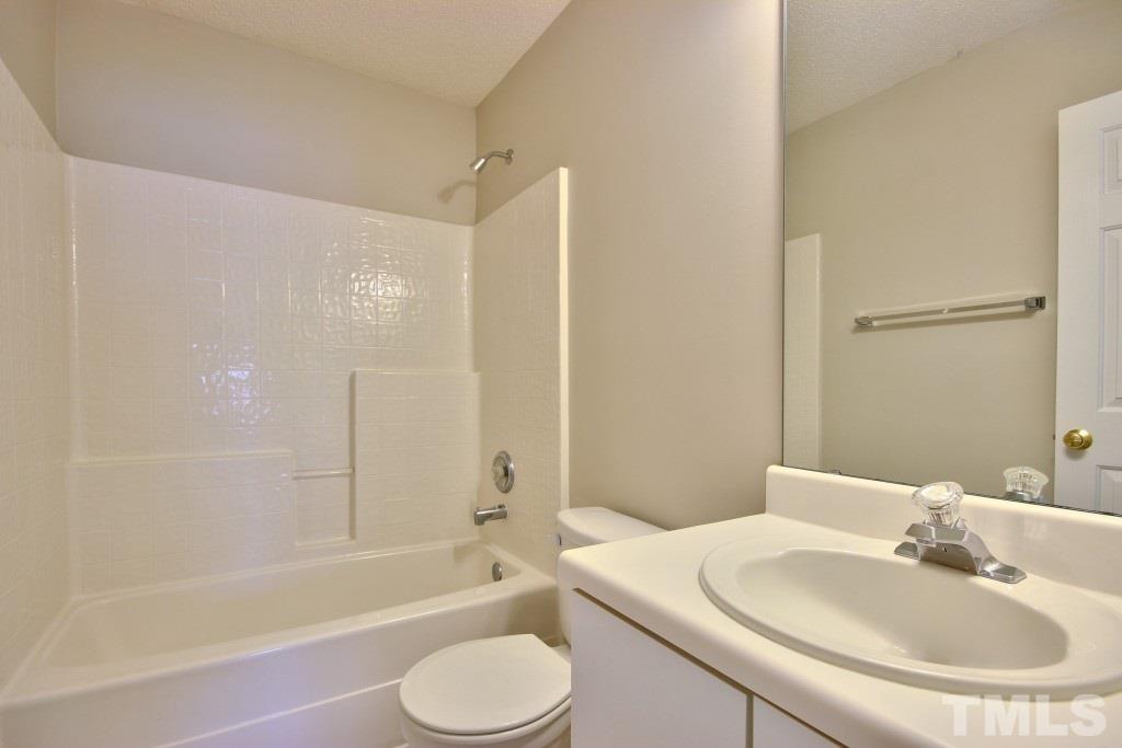 3800 Hopper Street Raleigh, NC 27616 - Photo 13 of 18 a bathroom with a sink toilet and shower