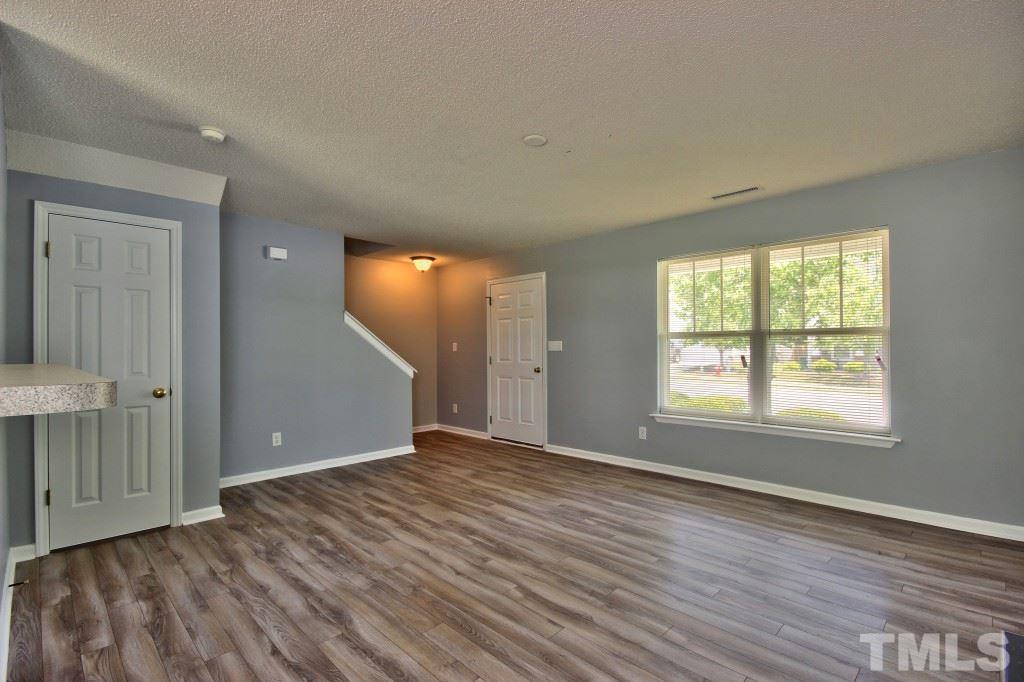 3800 Hopper Street Raleigh, NC 27616 - Photo 3 of 18 an empty room with wooden floor and windows