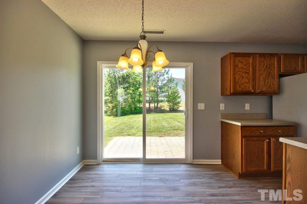 3800 Hopper Street Raleigh, NC 27616 - Photo 8 of 18 a kitchen with stainless steel appliances granite countertop a stove and a wooden floors