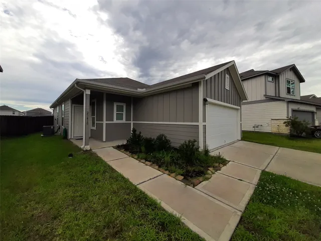 a front view of house with a garden
