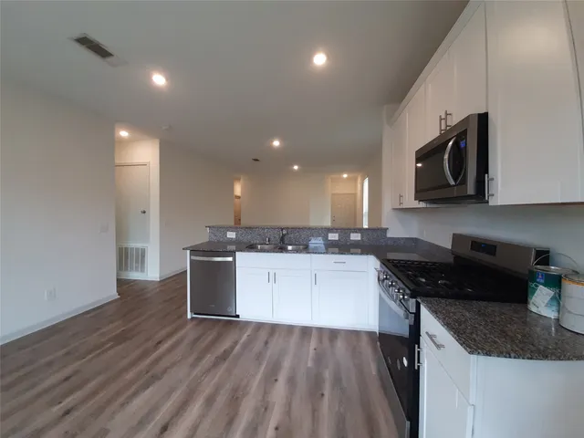 a kitchen with a sink and stove top oven